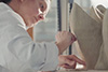 Close-up of a woman working on a ceramic piece