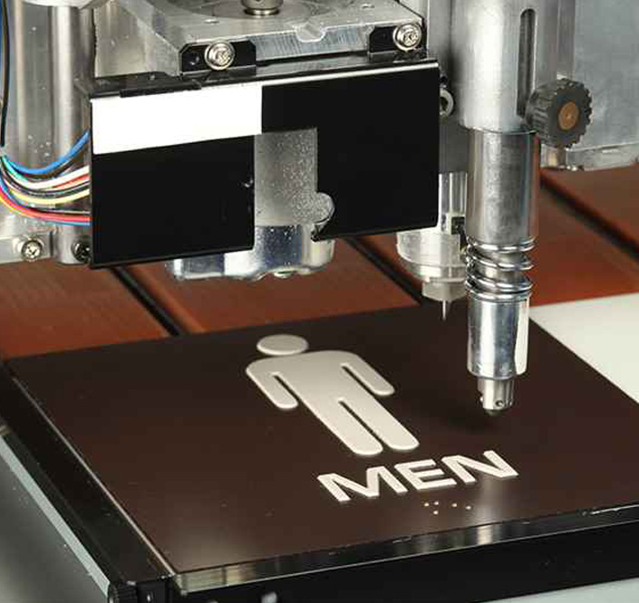 An engraving machine with a sign on it