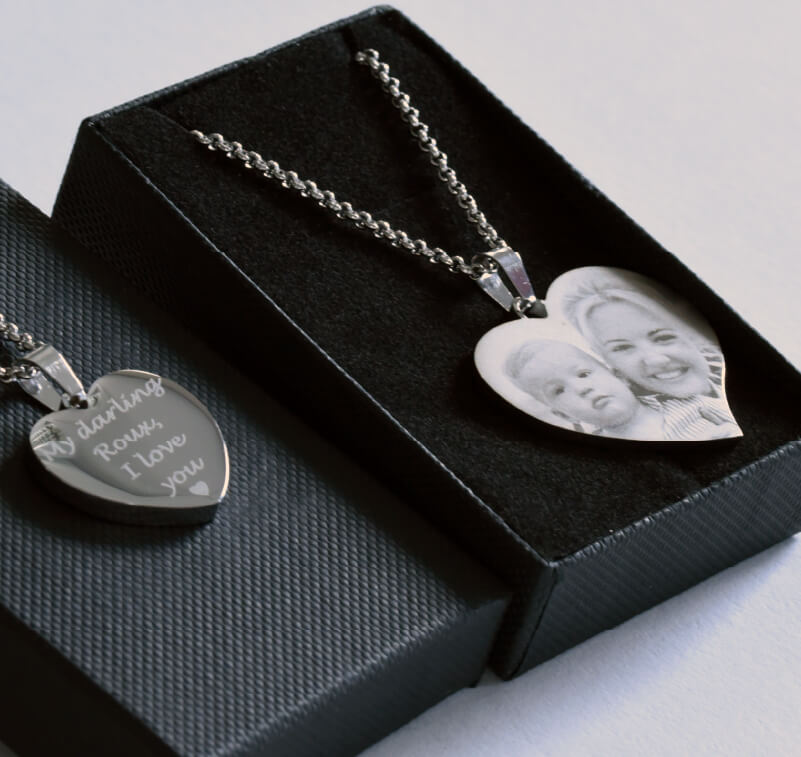 Two metal pendants engraved with text and photographs