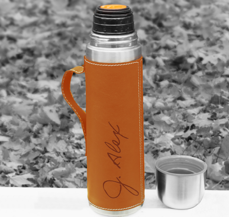 A flask with a custom-printed leather cover.
