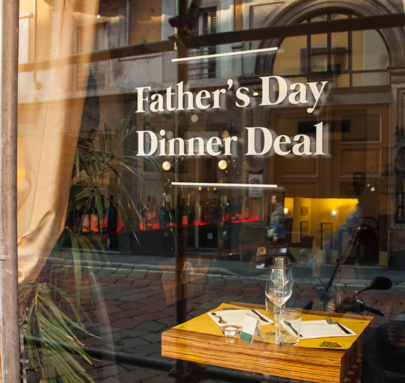 Temporary window graphics promoting a restaurant deal
