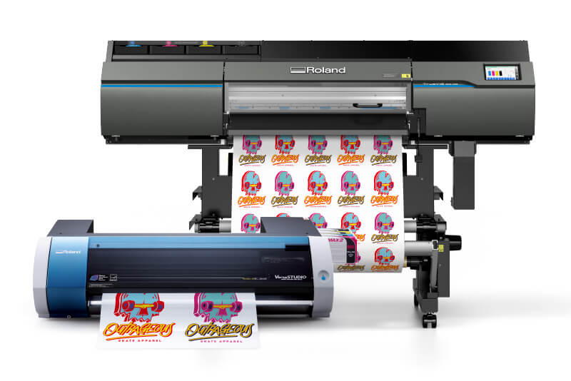 A small sticker printing machine in front of a larger one 