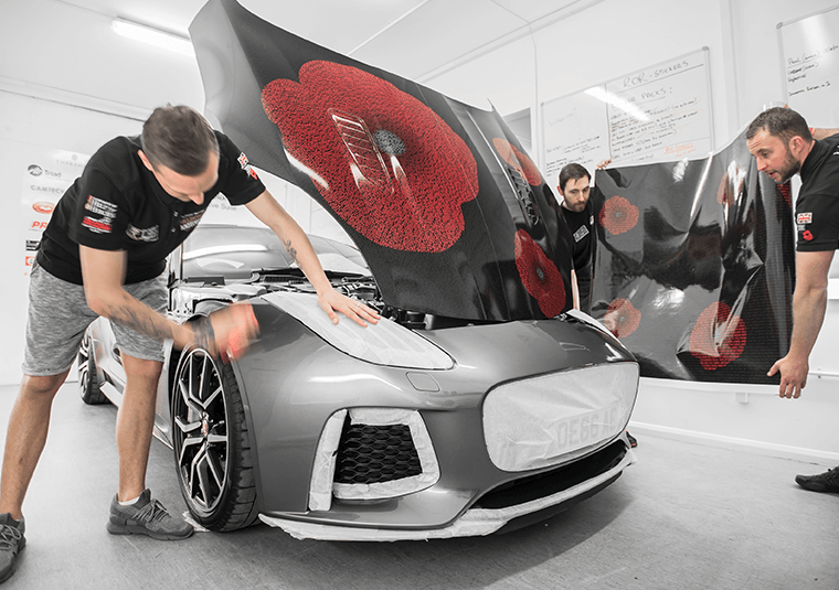 Mission Motorsport team wrapping a Jaguar F-Type