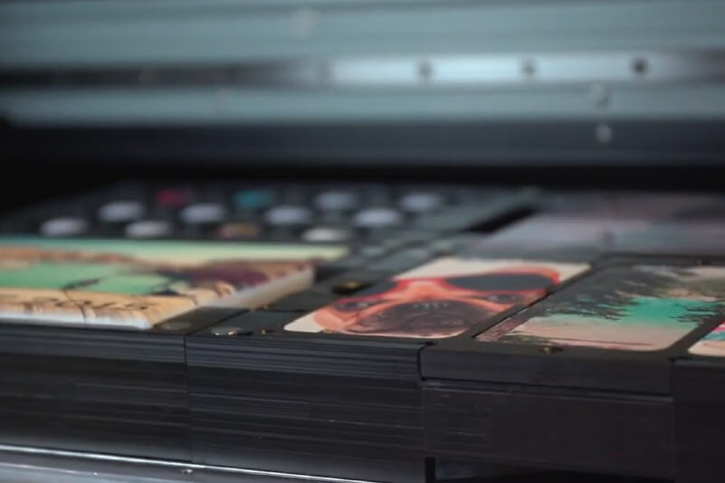 Ein Flachbettdrucker mit mehrfarbigen, individuellen Handyhüllen