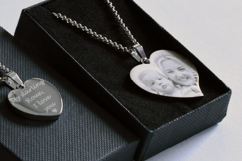 ATwo necklaces with engraved photos and text