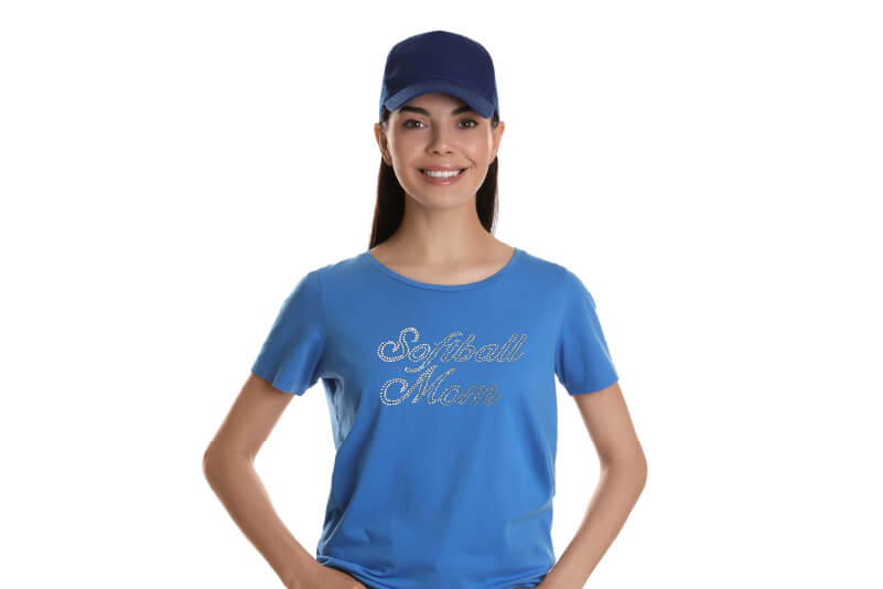 A woman wearing a blue t-shirt with rhinestone decoration