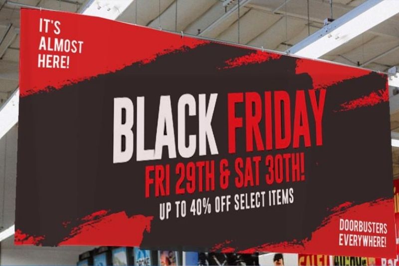 Black Friday sale banner printed in red and black ink and hanging from ceiling