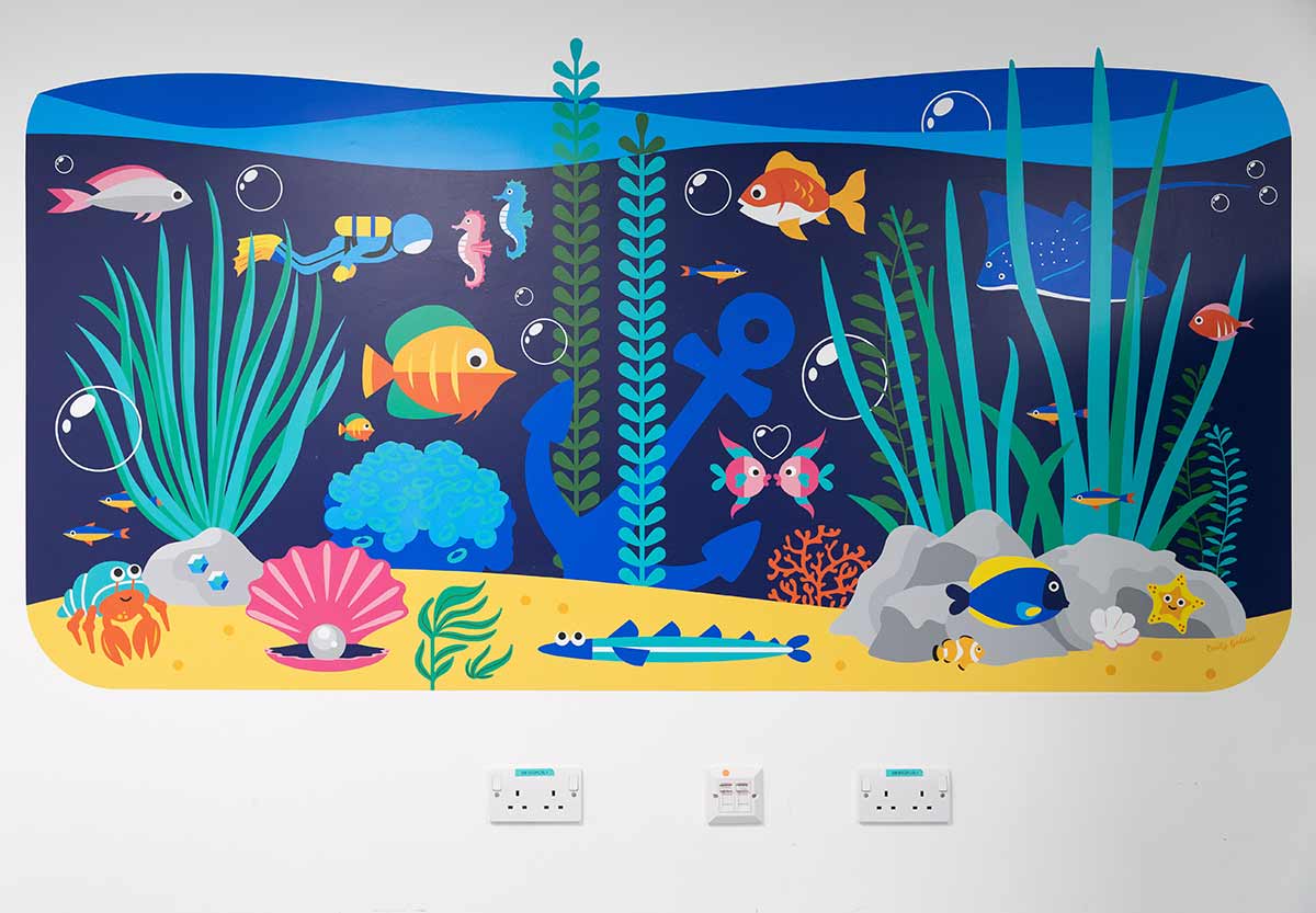 La grafica murale che riproduce il fondale sottomarino offre distrazione ai pazienti.