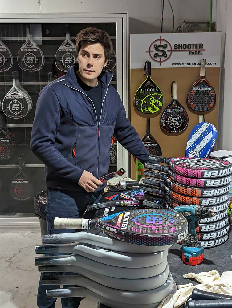 One of the founders with a pile of personalized racquets