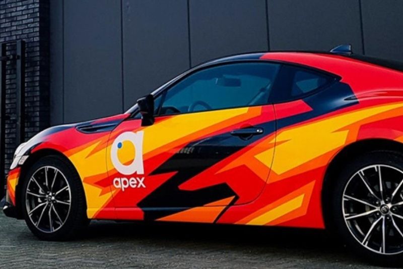 Black Fish Graphics fully wrapped car in red, yellow, orange, red and black vibrant design