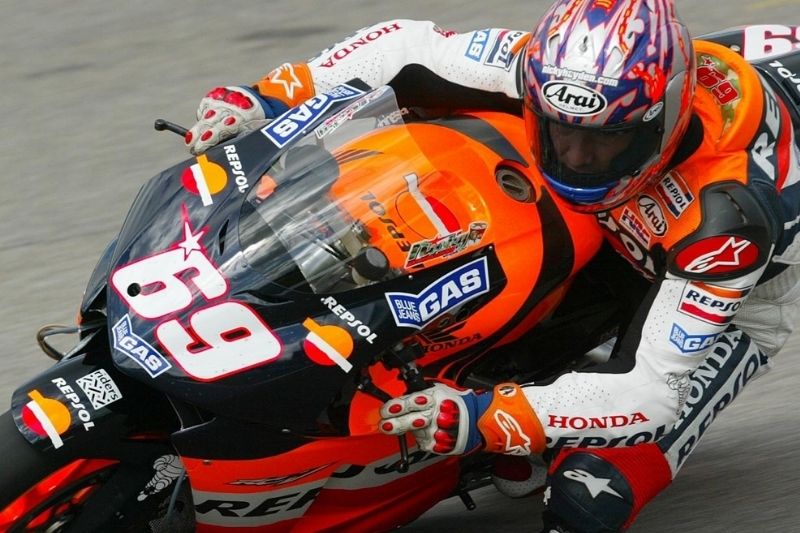 MOTO GP Motorcyclist on track riding fully branded bike, helmet and clothing